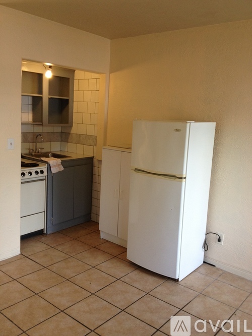 A kitchen with a white fridge and a white oven.