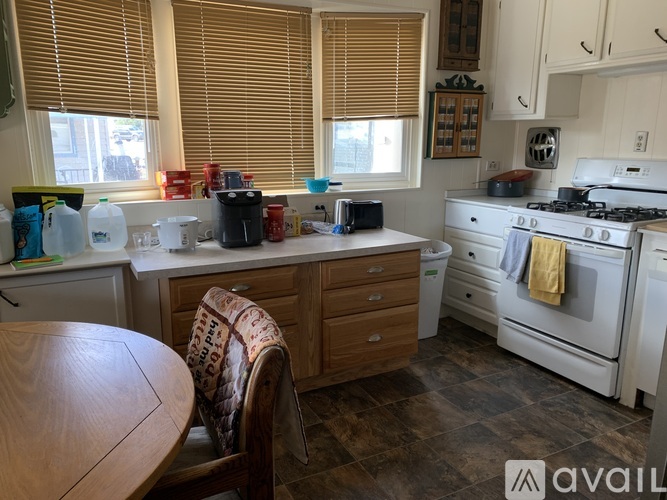 A kitchen with a wooden table and a white stove.