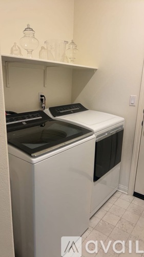 A white kitchen with a sink and stove top.