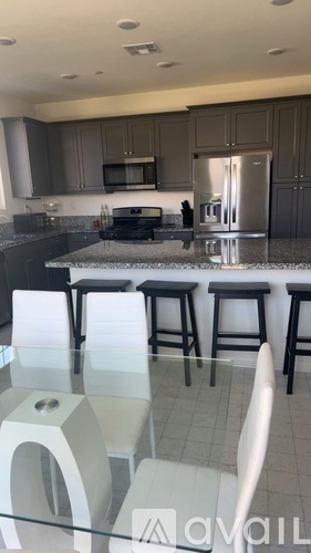 A kitchen with a bar area in front of it.