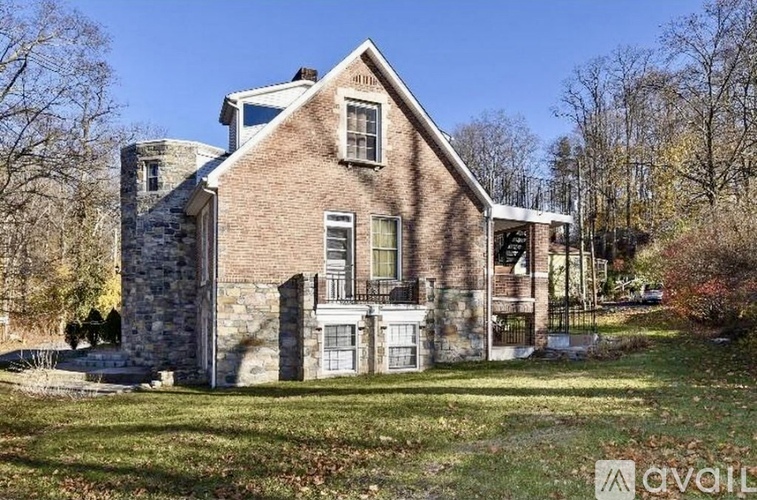 A large house with a stone foundation and a brick exterior.