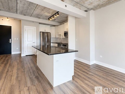 A room with wooden floors and a window with a view of trees.