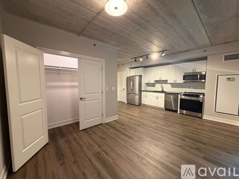 A kitchen area with a refrigerator, oven, and microwave.