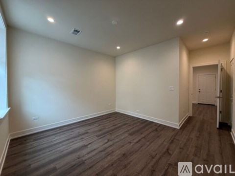 A bedroom with a large bed and a fireplace.