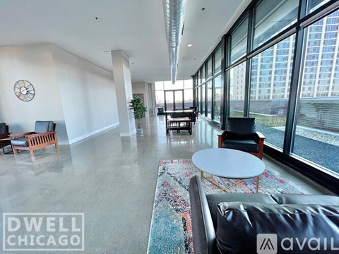 A living room with a large window and a view of a city skyline.