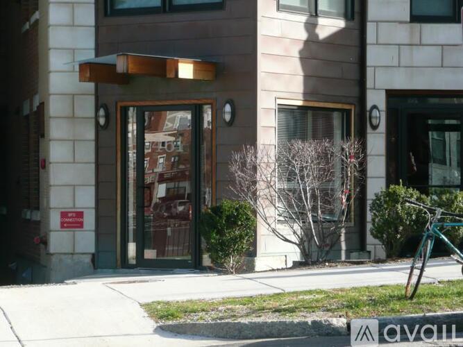 A building with a glass door and a bicycle parked in front.