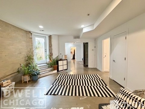 A black and white striped rug is on the floor of a spacious room.