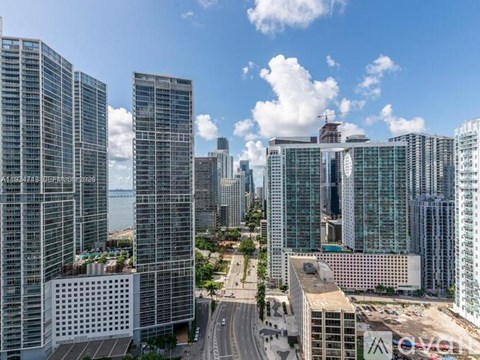 A cityscape with tall buildings and a clear sky.