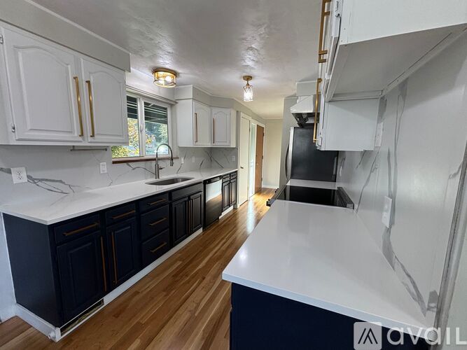 A kitchen with white and dark wood cabinets.