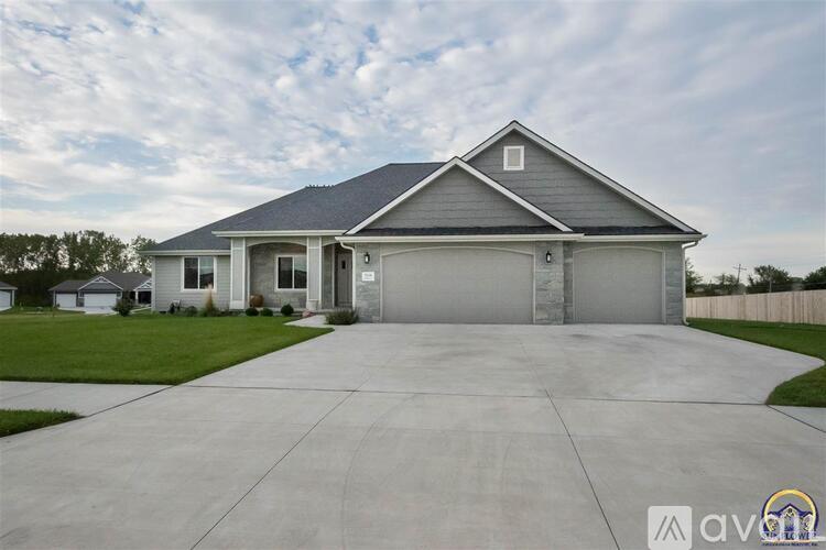 A two-story house with a garage is shown in the image.