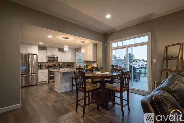 A modern kitchen with a dining table set for four.