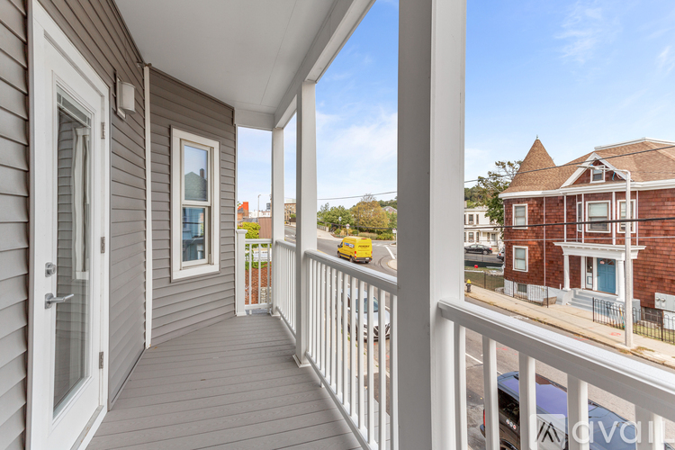 A balcony with a view of a street and buildings.