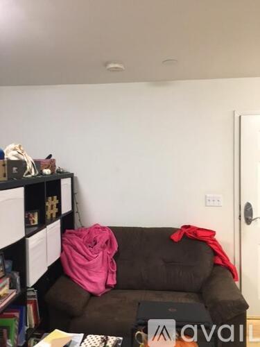 A living room with a couch and a bookshelf.