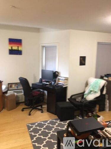 A room with a desk and a chair.