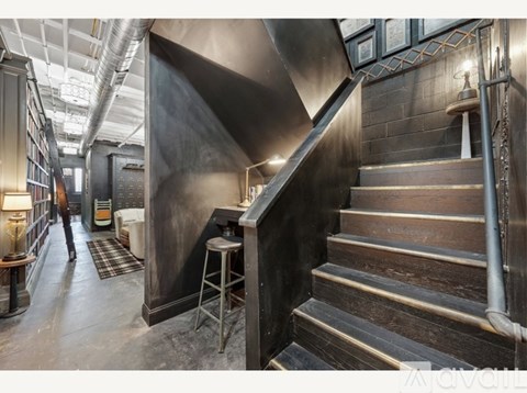A man is walking down a staircase in a building.
