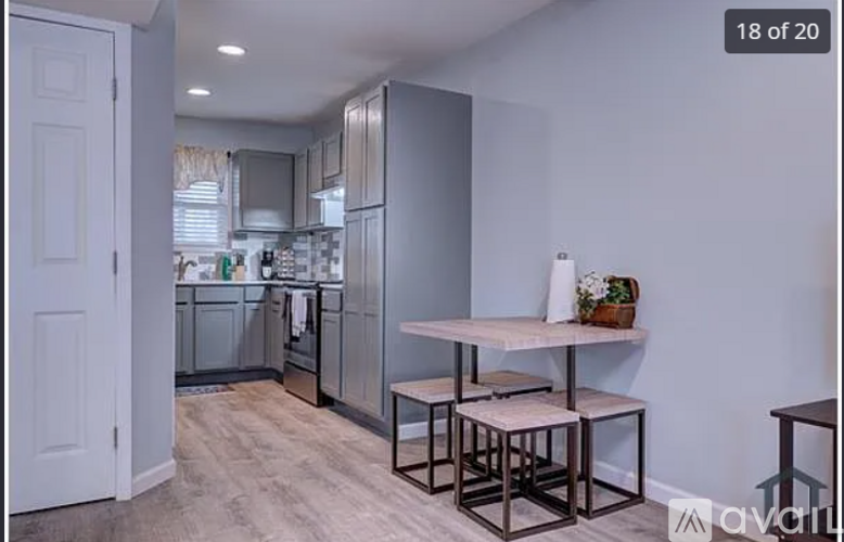 A kitchen with a table and chairs in the middle of the room.