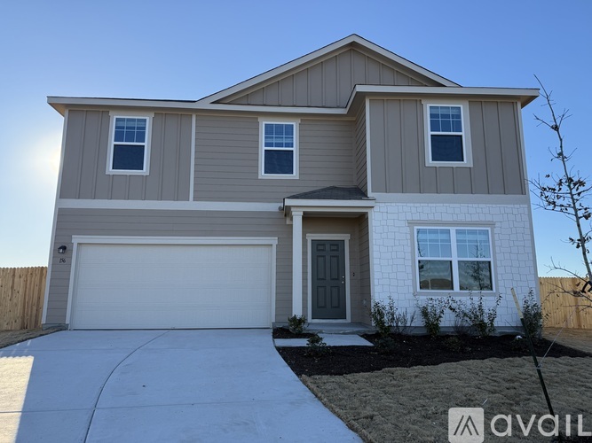 A two-story house with a garage and a front door.