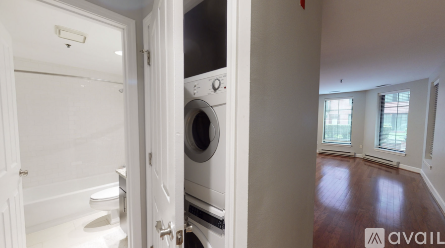 A washing machine is in a small laundry room.