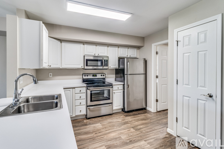A kitchen with white cabinets and stainless steel appliances.