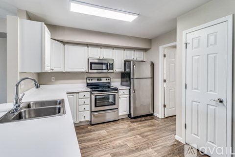 A kitchen with white cabinets and stainless steel appliances.