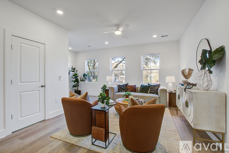 A living room with a brown chair and a glass table.