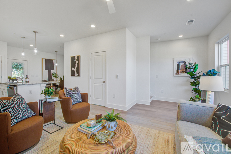 A living room with a brown sofa, a wooden coffee table, and a rug.