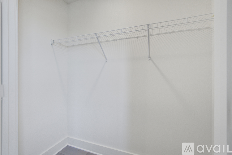 Empty white closet with a shelf.