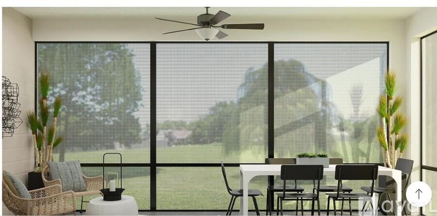 A dining room with a table set for four and a view of the backyard.
