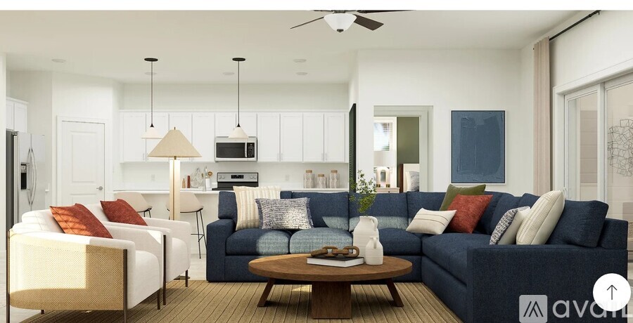 A modern living room with a dark blue sofa and a wooden coffee table.