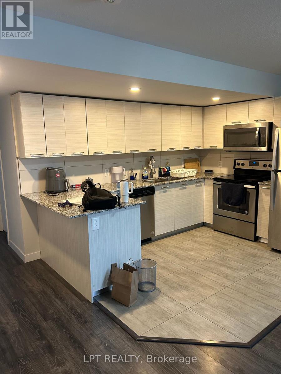 A kitchen with a white counter top and a black bag on it.