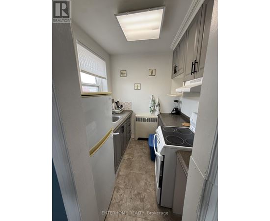 A small, clean kitchen with a washer and dryer.