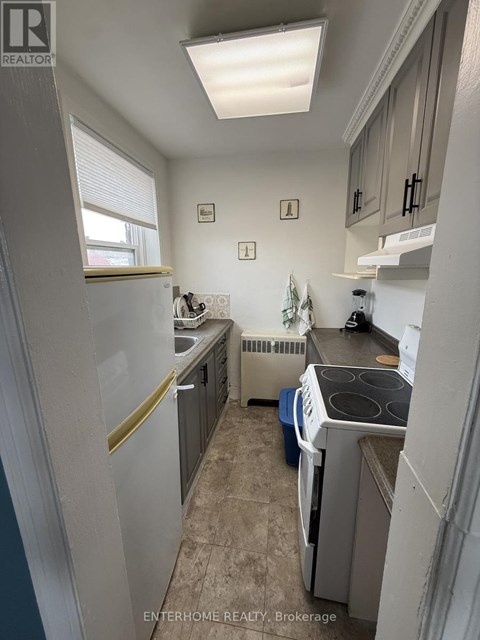 A small, clean kitchen with a washer and dryer.