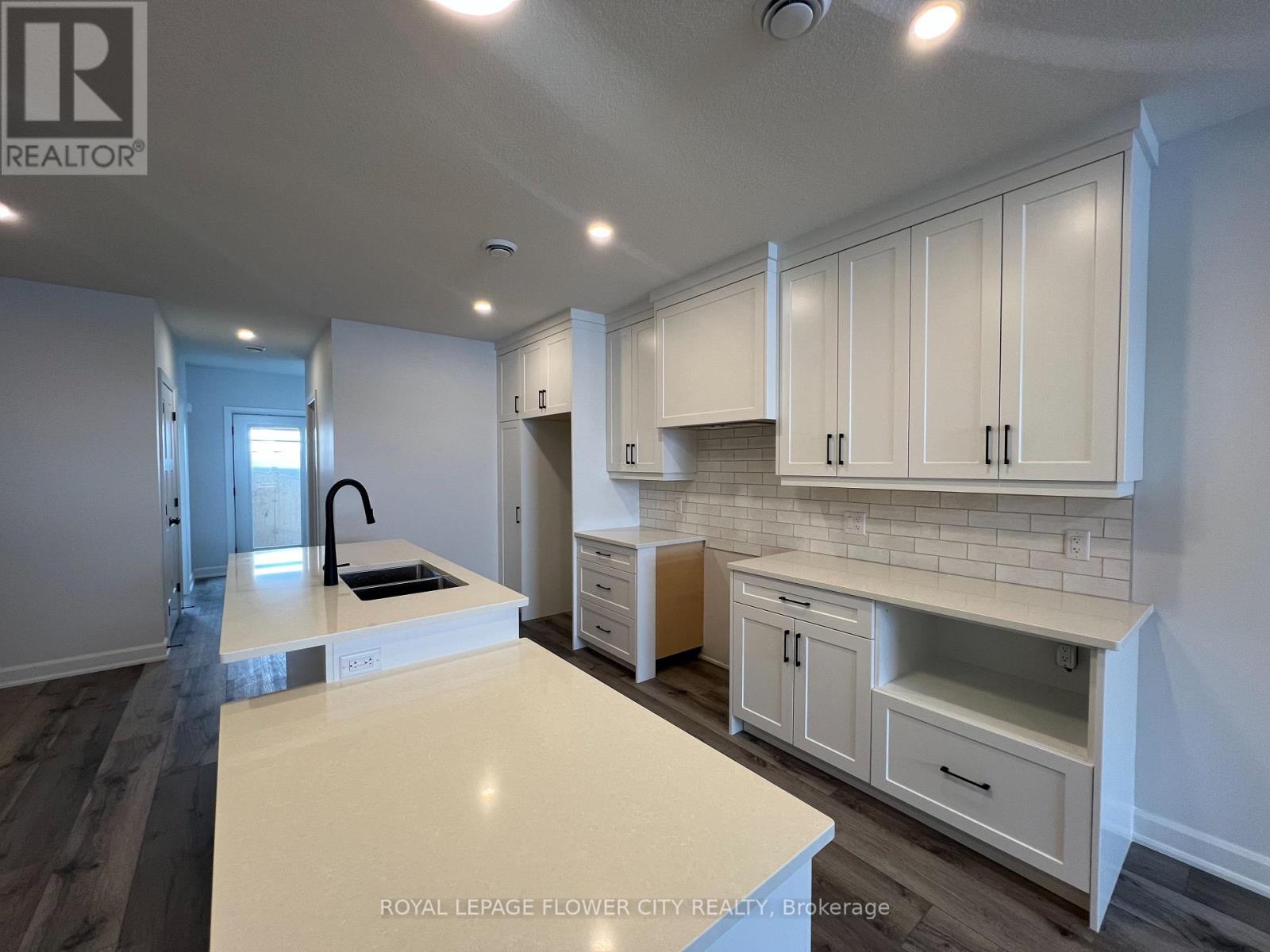 A kitchen with white cabinets and a countertop.