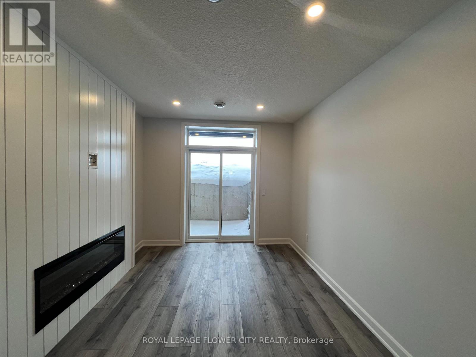 A room with a flat screen TV mounted on the wall.