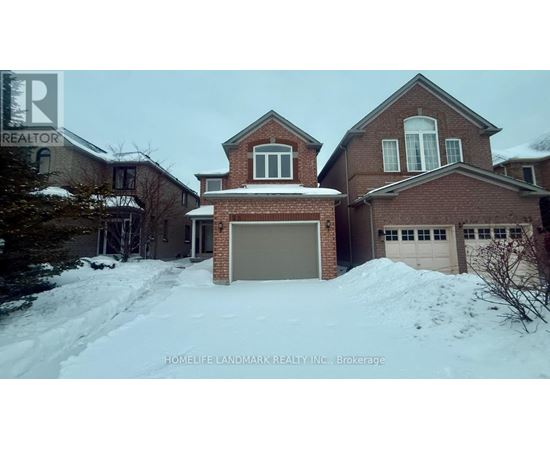 A large brick house with a snow-covered driveway in front.