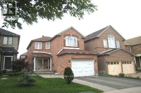 A large brick house with a white garage door in the front.