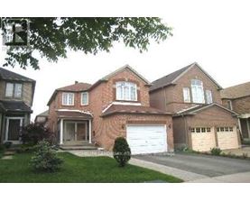 A large brick house with a white garage door in the front.