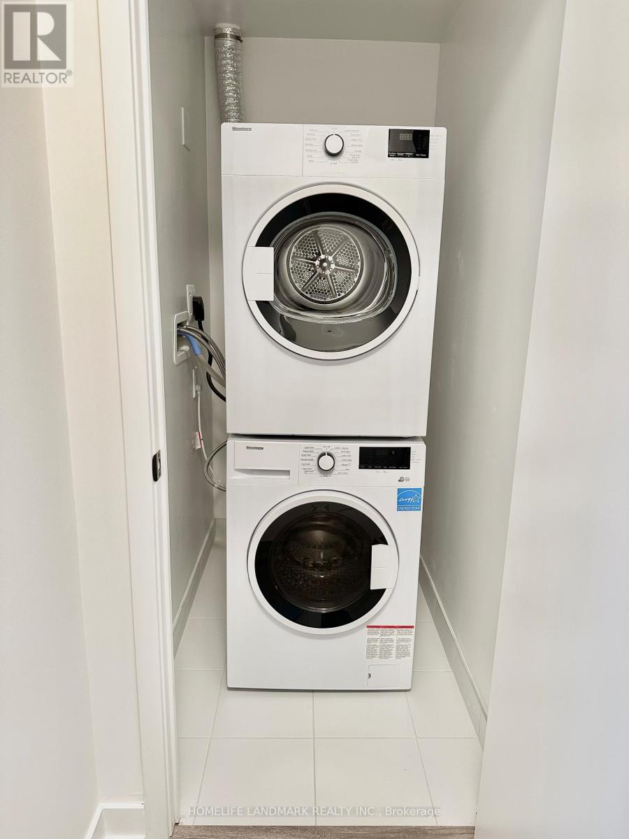 A white dryer and washer in a small laundry room.