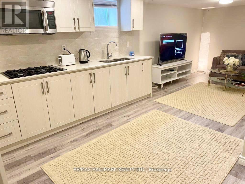 A kitchen with white cabinets and a tile backsplash.