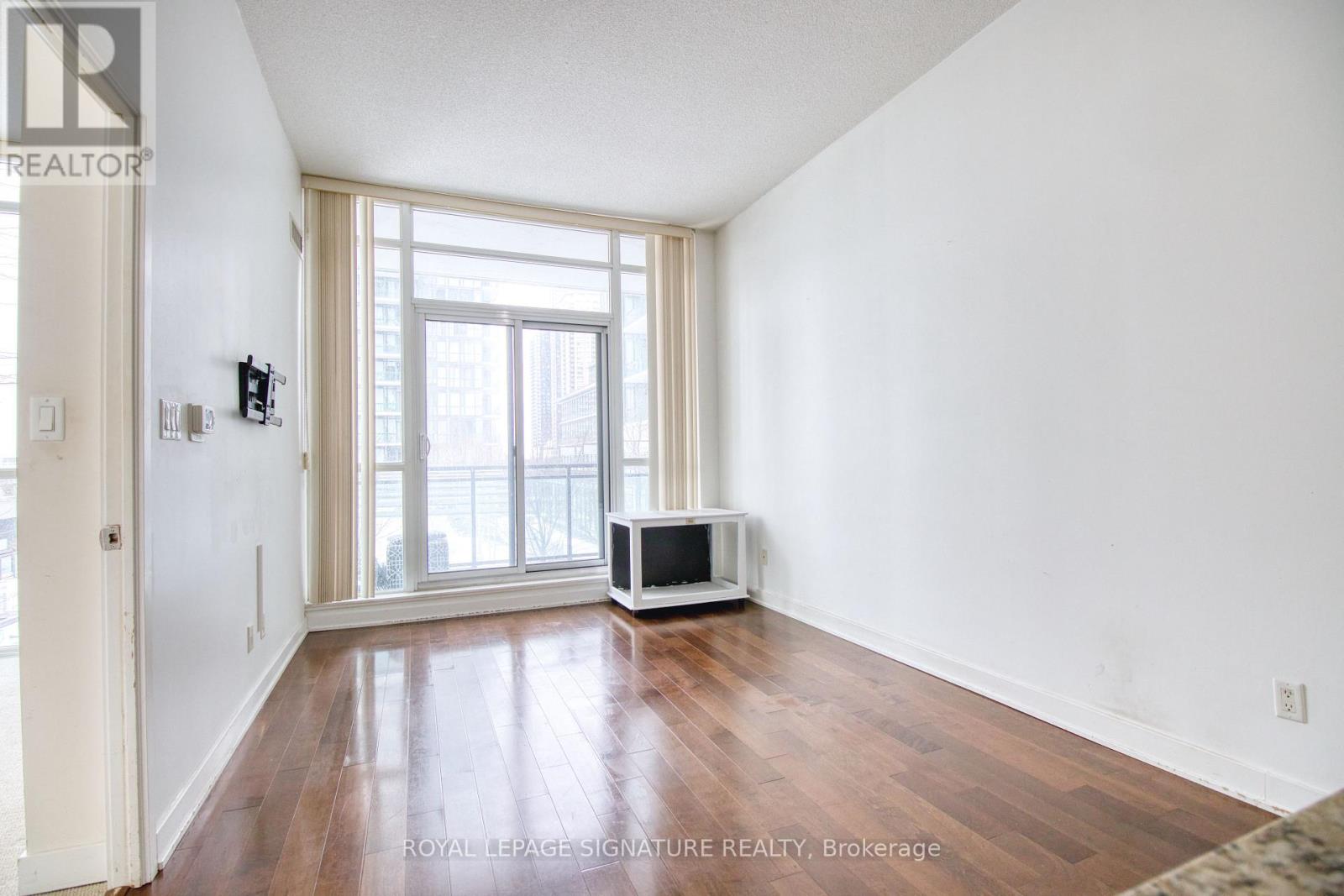 A room with a wooden floor and a window.