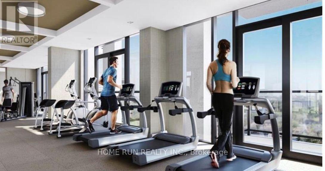 A gym with people exercising and a sign that says "REALTOR".