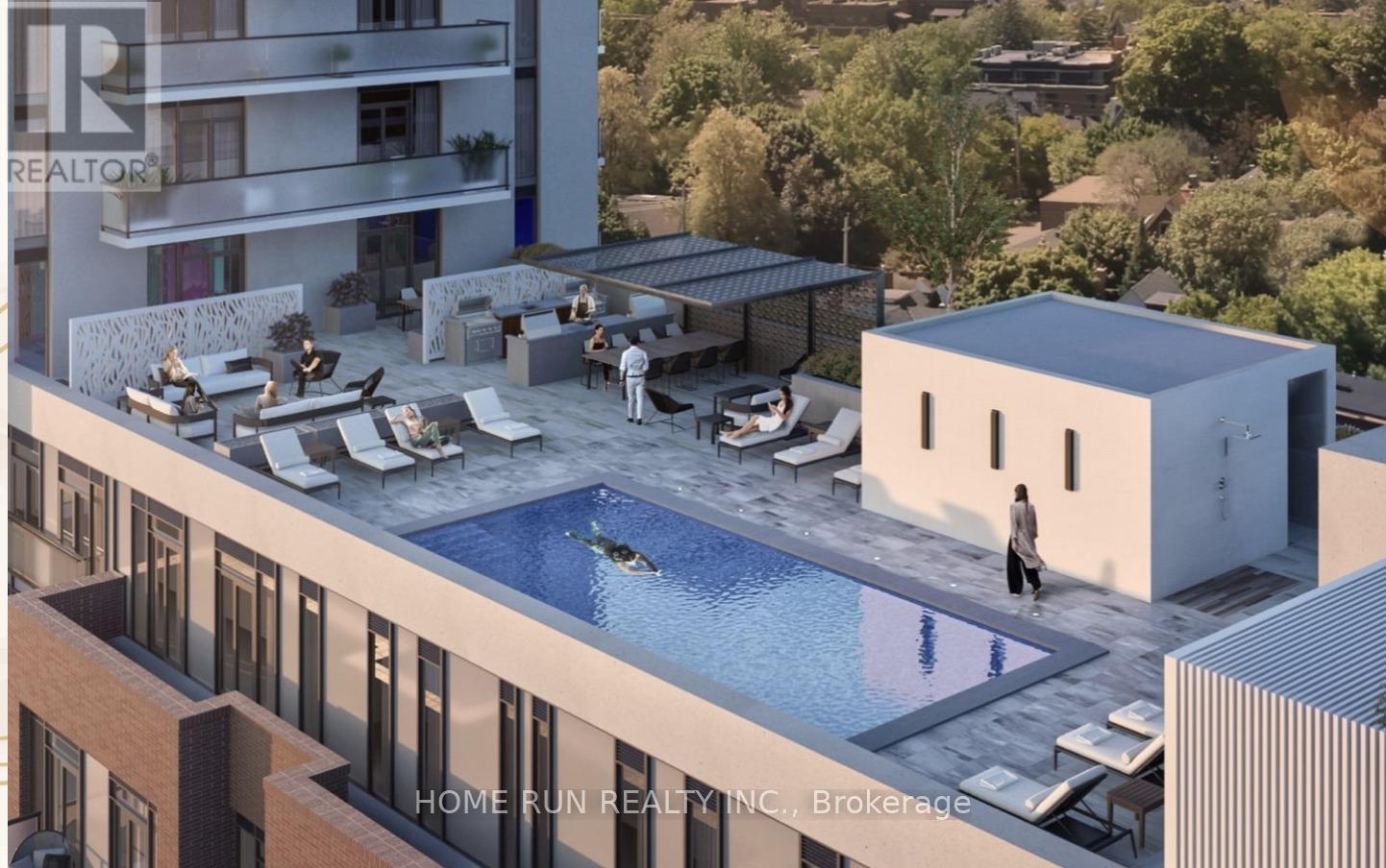A modern building with a pool and a person standing by it.