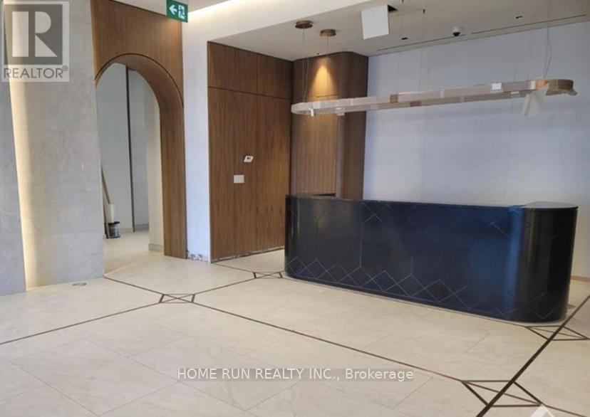 A reception area with a blue counter and a wooden door.