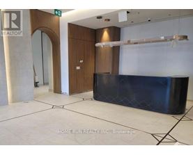 A reception area with a blue counter and a wooden door.