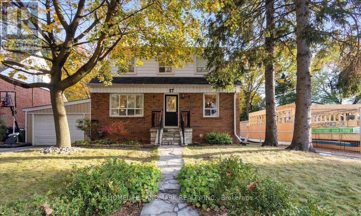 A brick house with a tree in front of it.