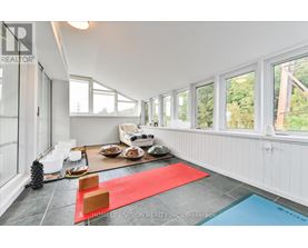 A bright room with a red rug and a pool table.