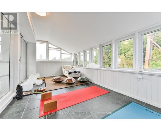 A bright room with a red rug and a pool table.