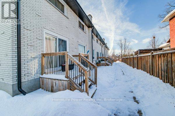 A snow-covered front yard of a residential building.