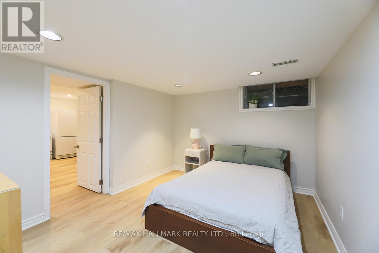 A bedroom with a bed, nightstand, and lamp.