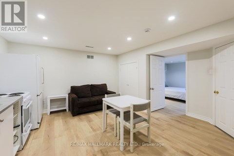 A living room with a brown couch and a white table.